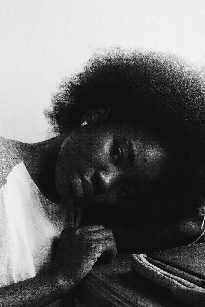 a black and white photo of a woman laying on a bed